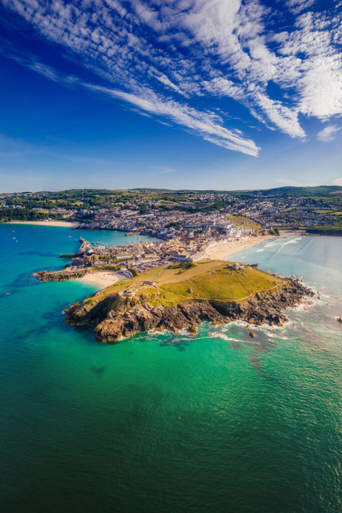 Aerial view of the rocky shore and town surrounded by sea. St Ives, Cornwall, England, UK.
