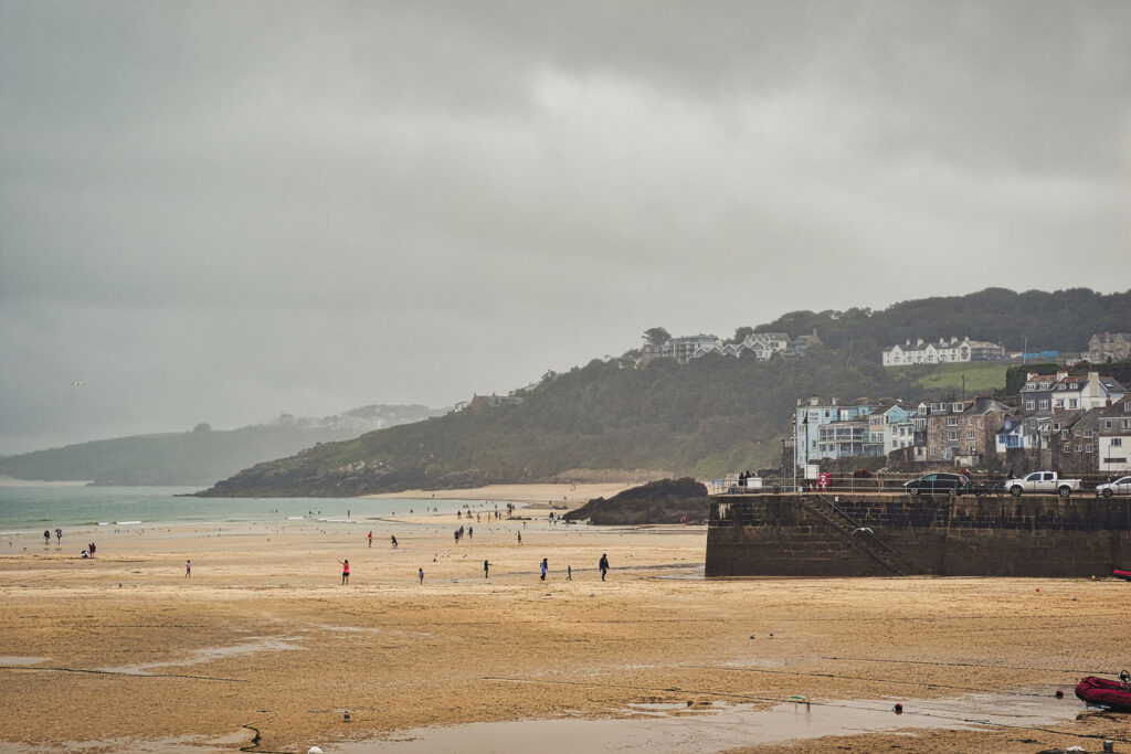 Coastal Beach Scene Under Cloudy Sky in St Ives, Cornwall, UK