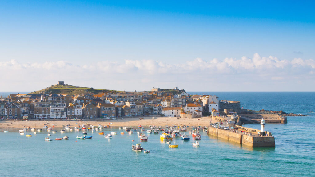 Coastal scene of St Ives, Cornwall, featuring sandy beaches and colourful buildings, one of Cornwall's best towns and villages to visit.