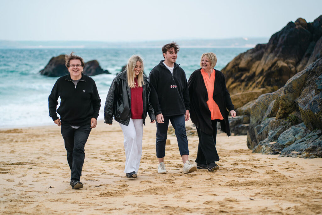 The family behind Cornish Escapes, walking on Porthgwidden Beach in St Ives, who can provide all the help you need with holiday cottage ownership.