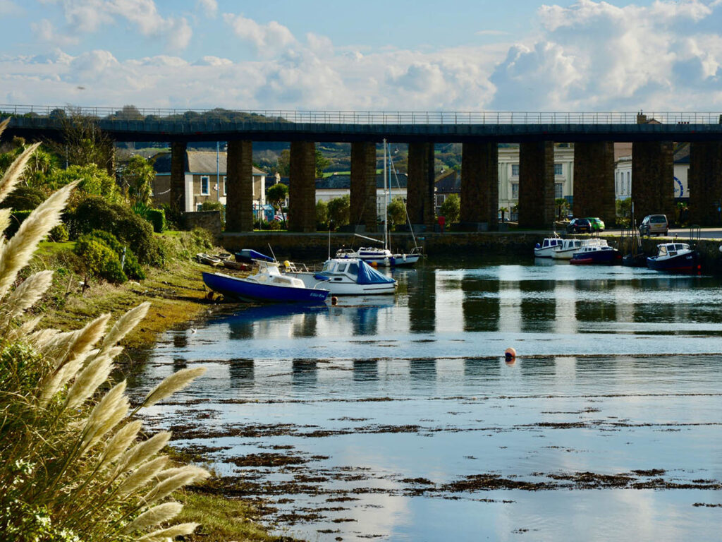 A historic view of the Hayle Railway bridge crossing over the water, highlighting its importance in history in Hayle.