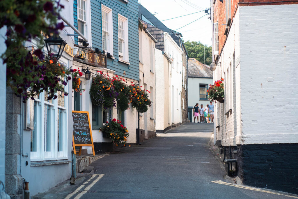 A narrow street in Padstow, flanked by buildings on both sides, showcasing local charm and character, with hidden secrets and tips from locals.