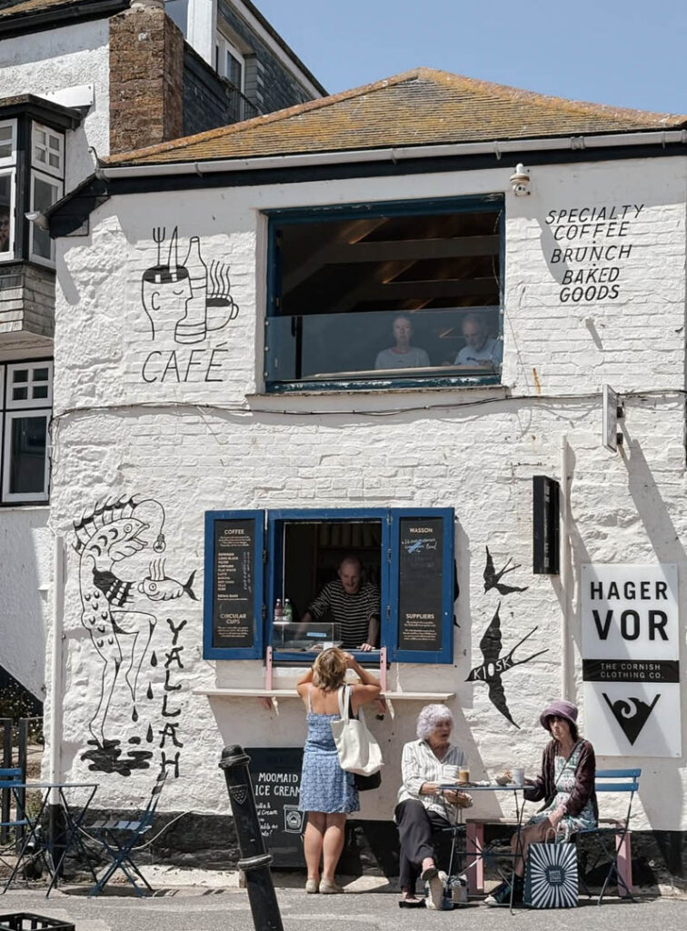 People enjoying coffee outside Yallah Cafe in St Ives, an independent shop in St Ives.
