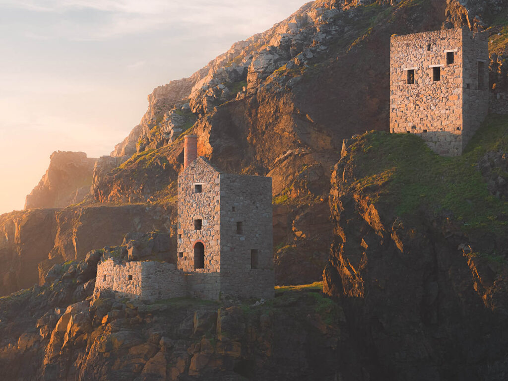 The majestic Botallack Mine perched on a cliff, overlooking the rugged coastline near St Just in Cornwall, a great place to visit from Cornwall holiday cottages.