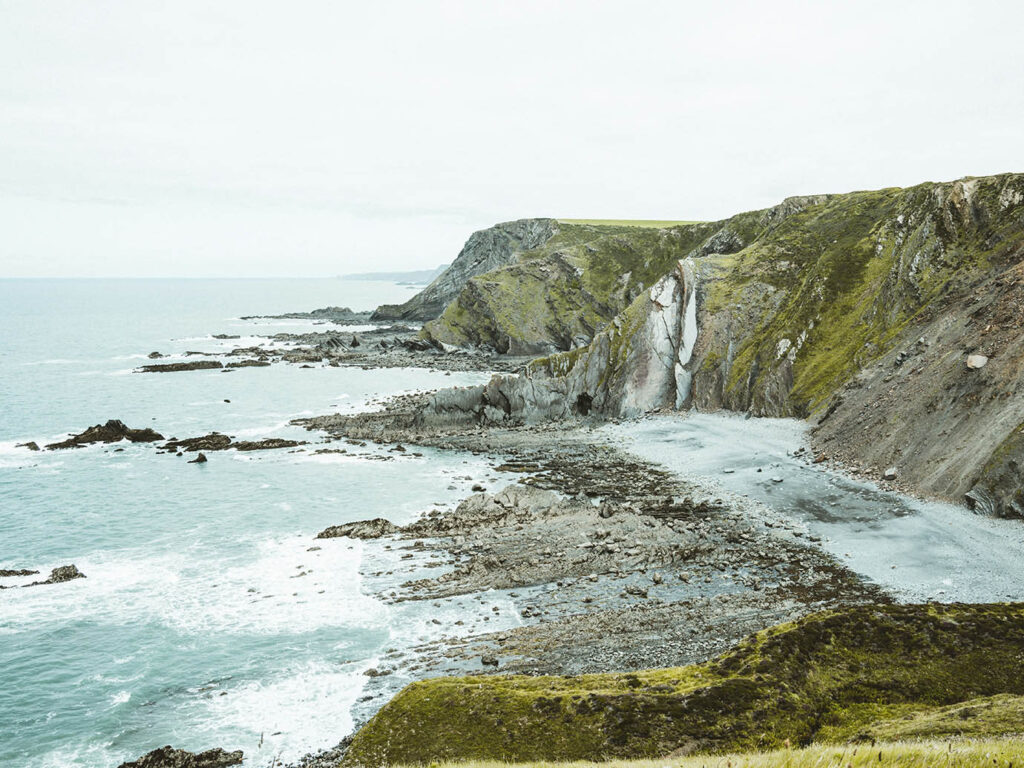 Scenic view of the ocean and cliffs from a hilltop at Morwenstow Beach, near Bude, Cornwall, a great place to visit from a Cornwall holiday cottage.