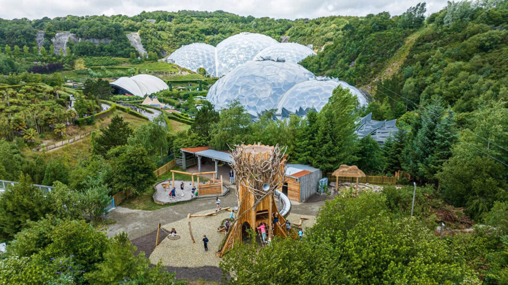 Colourful biomes of the Eden Project surrounded by lush gardens, perfect for family exploration and summer fun, a great thing to do in Cornwall with the kids this Summer.
