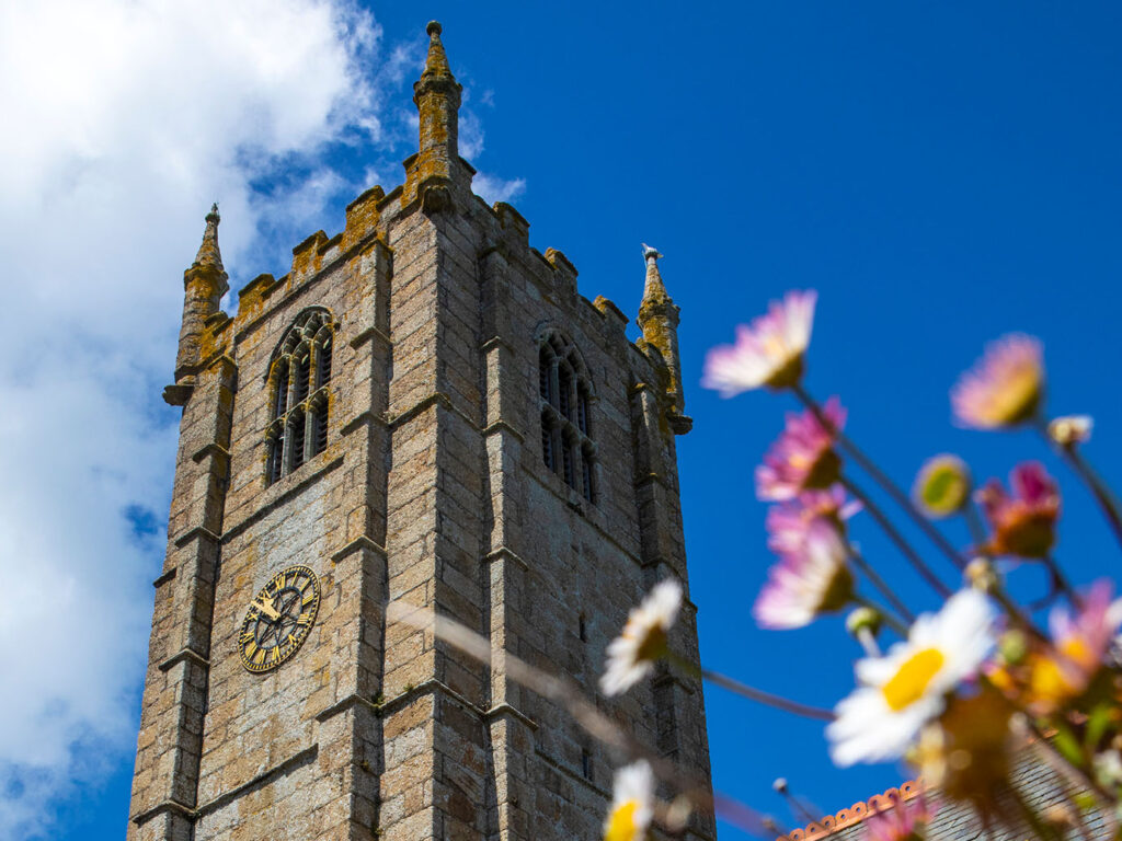 The tall St Ia Church in St Ives, showcasing its striking bell tower and beautiful architectural details, a great piece of arts and heritage in St Ives.