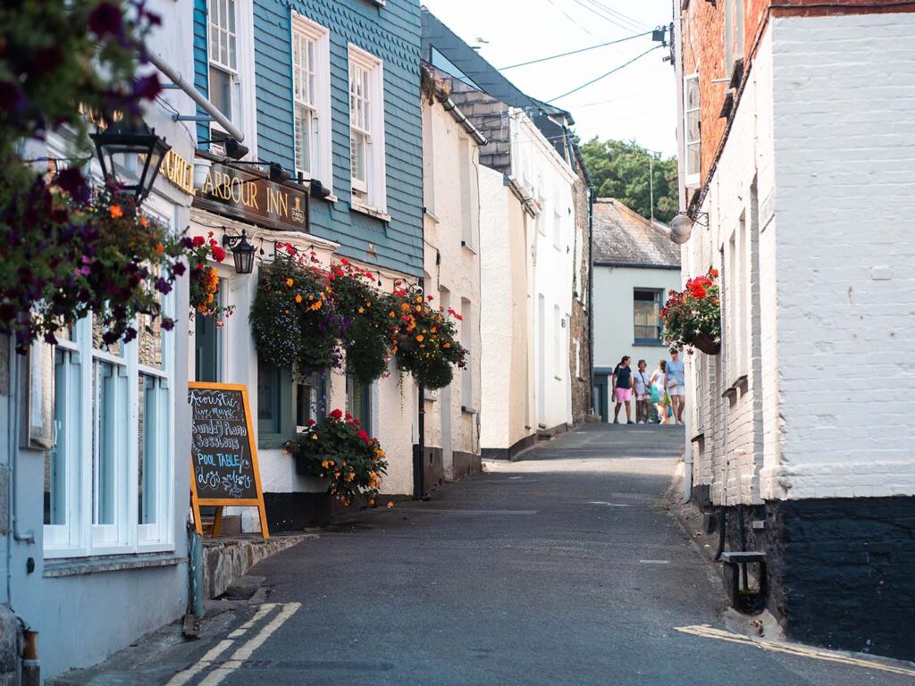 A picturesque narrow street in Padstow, lined with buildings, showcasing the town's unique character and food and drink scene.