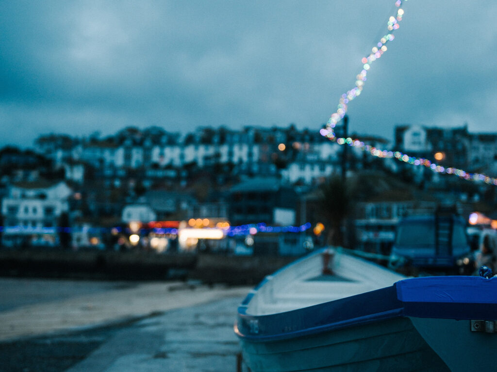 A vibrant boat is anchored at St Ives Harbour, a key part of St Ives art and heritage.